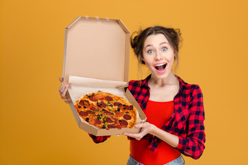 Portrait of charming amusing young woman holding pizza