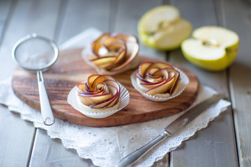 Homemade Apple rose cake on wooden background, selective focus