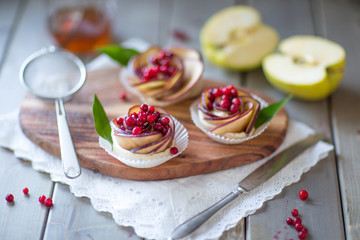 Homemade Apple rose cake on wooden background, selective focus
