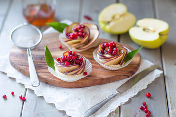 Homemade Apple rose cake on wooden background, selective focus