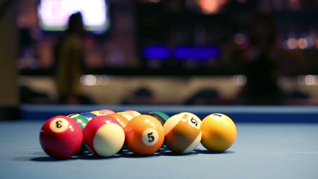 Playing Eight-ball pool billiards in a bar