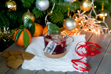 Mulled wine against the backdrop of the Christmas tree. Selective focus