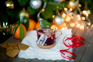Mulled wine against the backdrop of the Christmas tree. Selective focus