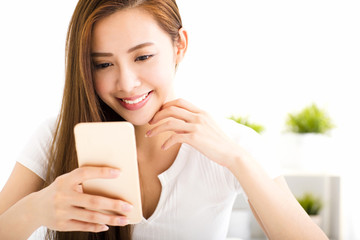 young beautiful woman reading message with smart phone