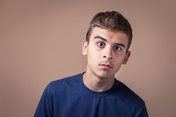 Confused teenager with eyes wide open. Horizontal orientation background.