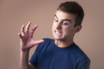 Naklejka premium Teenager under stress. Aggressive young man.