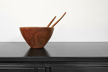 Empty wooden bowl with spoon and fork