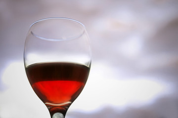 Glass of red wine on blurred background