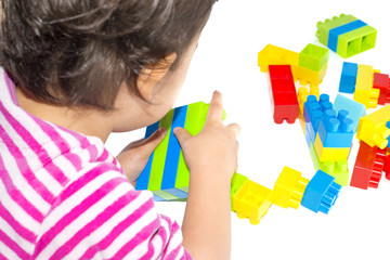 Baby girl playing with colorful blocks on white background