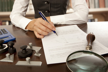 Notary signs the documents in office