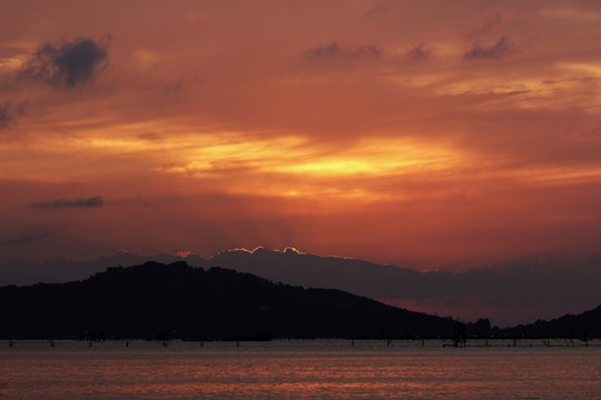 Red and gold colors of the sunrise and sunset. The Songkhla lake