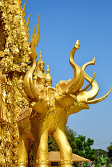 Golden elephants on a temple wall of Thailand