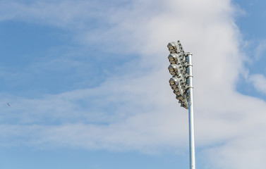 Spotlights soccer stadium with blue sky