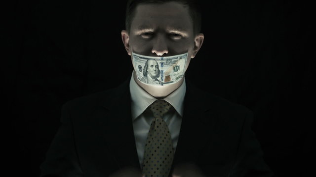 Corruption, person with scary face closed his mouth by the money