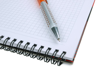 Paper notepad with a blank page and pen