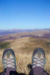 Hikers with backpacks enjoying valley view from top of a mountain