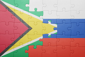 puzzle with the national flag of guyana and russia