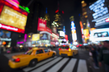 Defocus view of Times Square signage, traffic, and holiday crowds in the lead-up to New Year's Eve