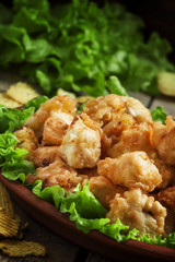Nuggets, chicken tempura with green salad and tomato sauce on a