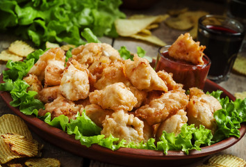 Nuggets, chicken tempura with green salad and tomato sauce on a