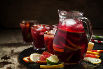 Sangria in pitcher with slices of fruit and ice, selective focus - obrazy, fototapety, plakaty