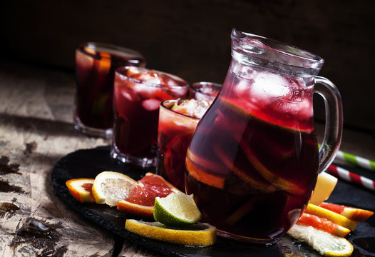 Sangria in pitcher with slices of fruit and ice, selective focus