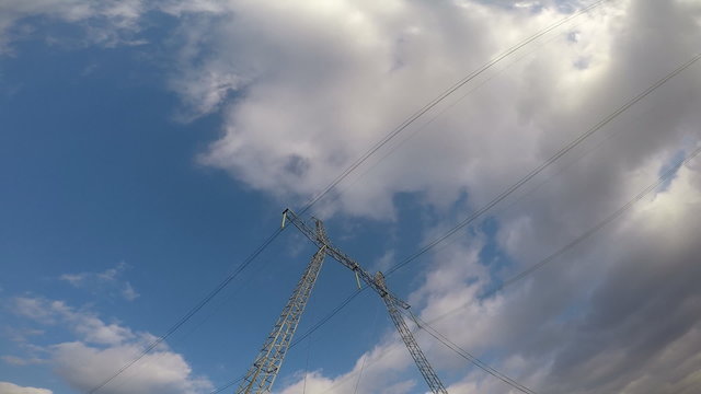 Electric high voltage pylon against sky. 
