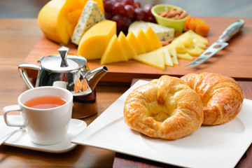 Breakfast with croissant, tea and cheese