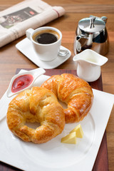 Continental breakfast with croissant, jam and coffee