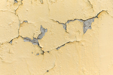 peeling yellow and white paint on a rough surface