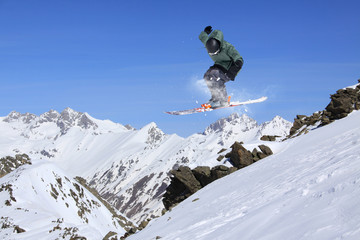 Flying skier on mountains. Extreme sport.