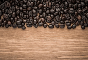 background of brown coffee beans on wood board