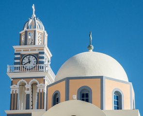 A Greek Orthodox church and clock tower near Fira town on the island of Santorini