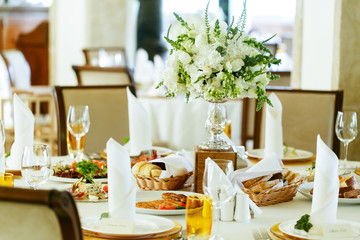 Elegant stylish decorated wedding reception tables with glasses