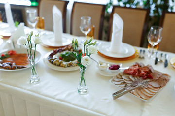 Elegant stylish decorated wedding reception tables with glasses