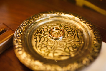 Two minimalistic beautiful wedding rings silver and gold on anti