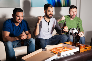Friends enjoying a soccer game on tv