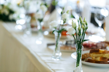 Elegant stylish decorated wedding reception tables with glasses