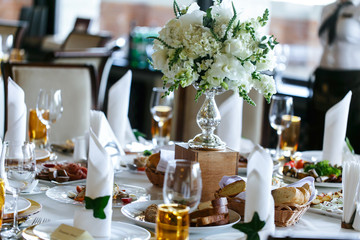 Elegant stylish decorated wedding reception tables with glasses