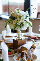 Elegant stylish decorated wedding reception tables with glasses