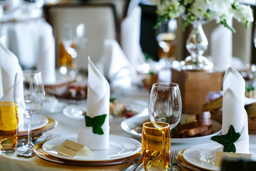 Elegant stylish decorated wedding reception tables with glasses