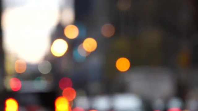 A look at colorful, round New York City traffic lights during a busy day in bokeh effect.
