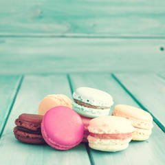 Colorful macaroons over turquoise wood