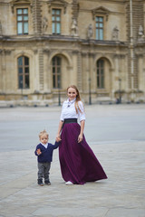 Fototapeta premium Beautiful young mother and her adorable toddler son in Paris