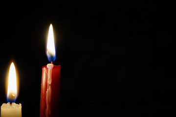 burning candle isolated on black
