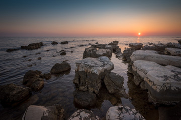 Sunset Over the Sea with Rocks in Foreground