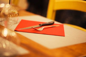 table setting with napkin, silverware in a bright red color