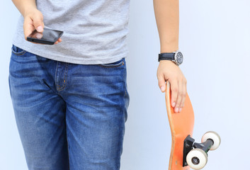 skateboarder use cellphone lean on wall