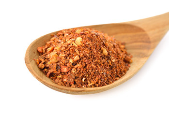 ground chili powdered in wooden on white background