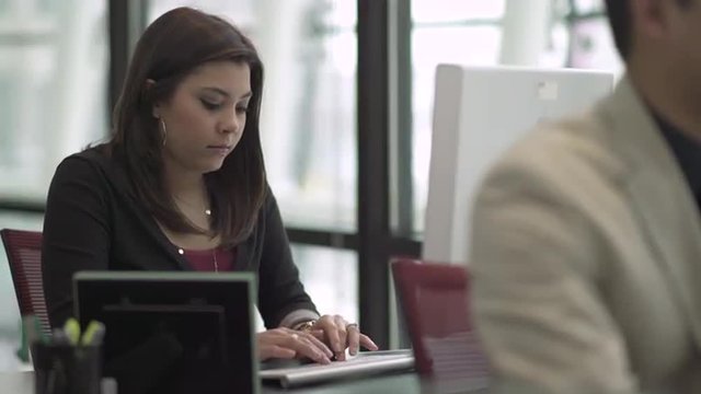 Professional in modern call center using headset and keyboard